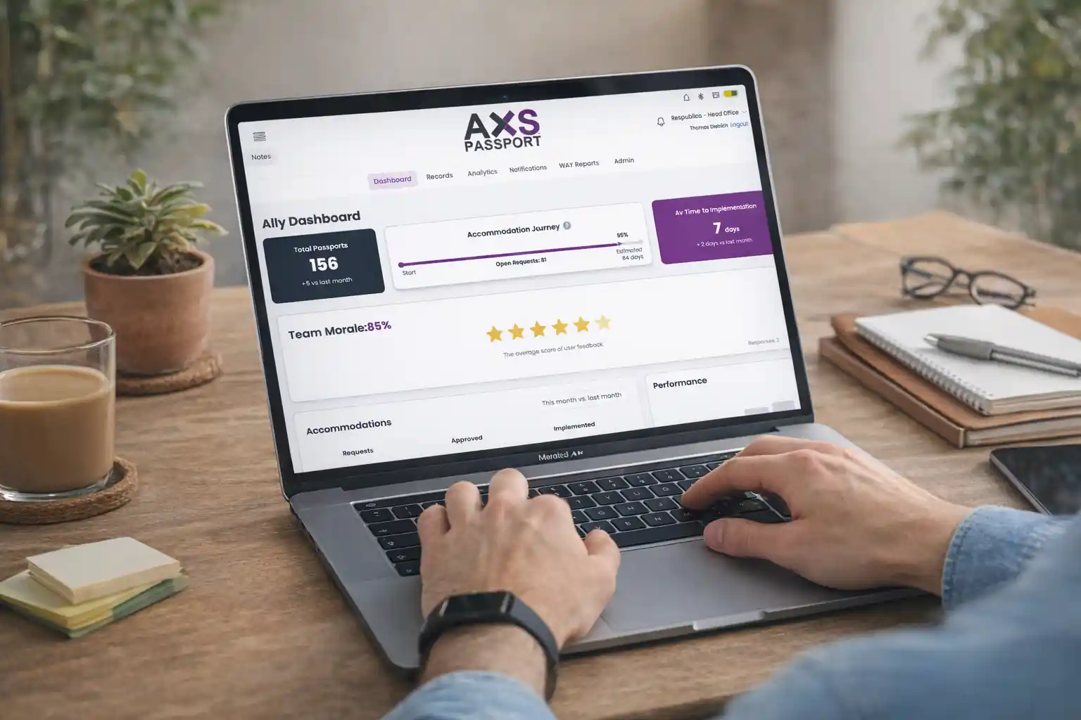 A person holding a tablet displaying the AXS Passport digital accessibility profile interface